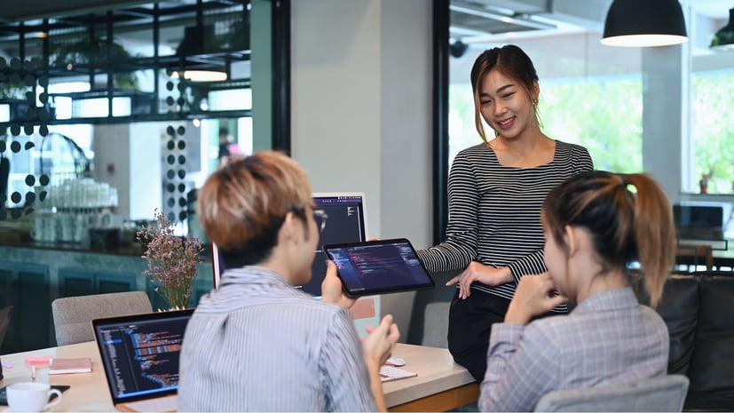 coworkers looking at a device