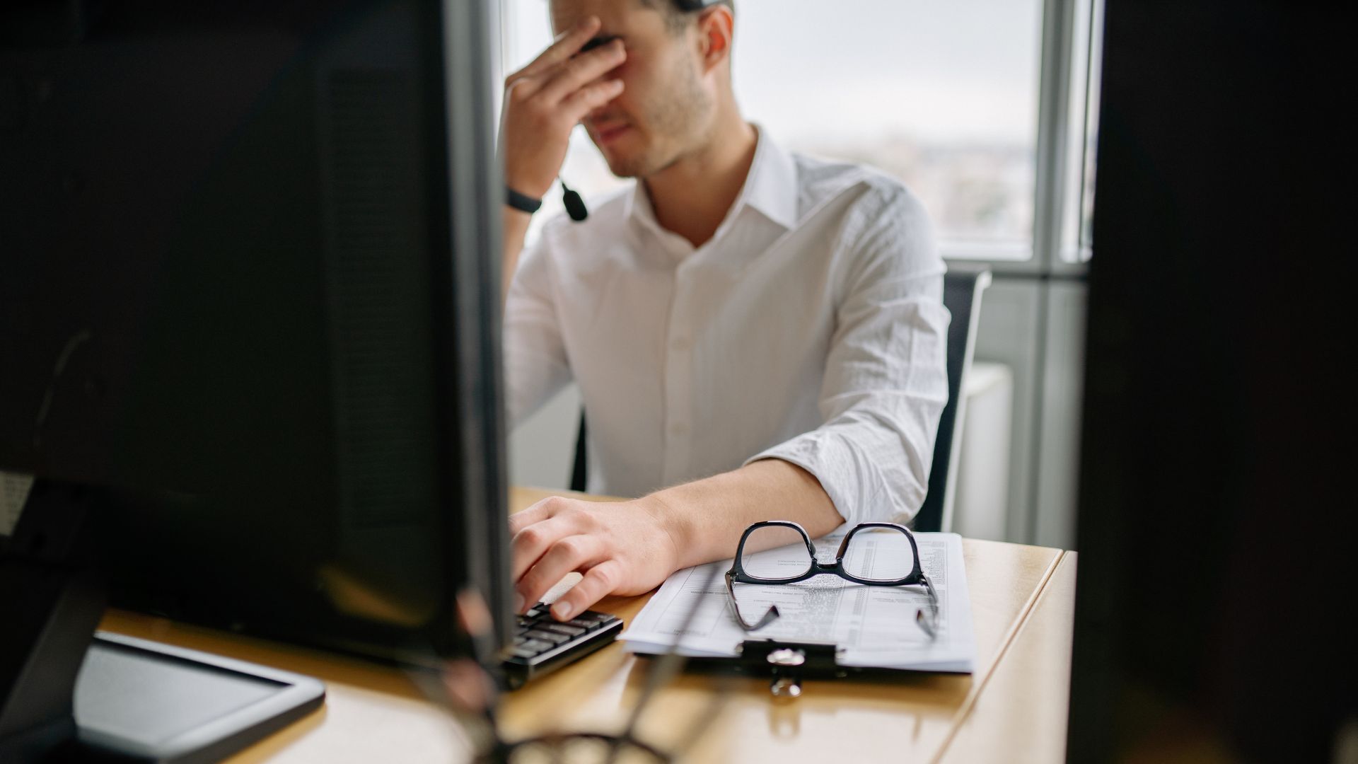 image of frustrated man at a computer